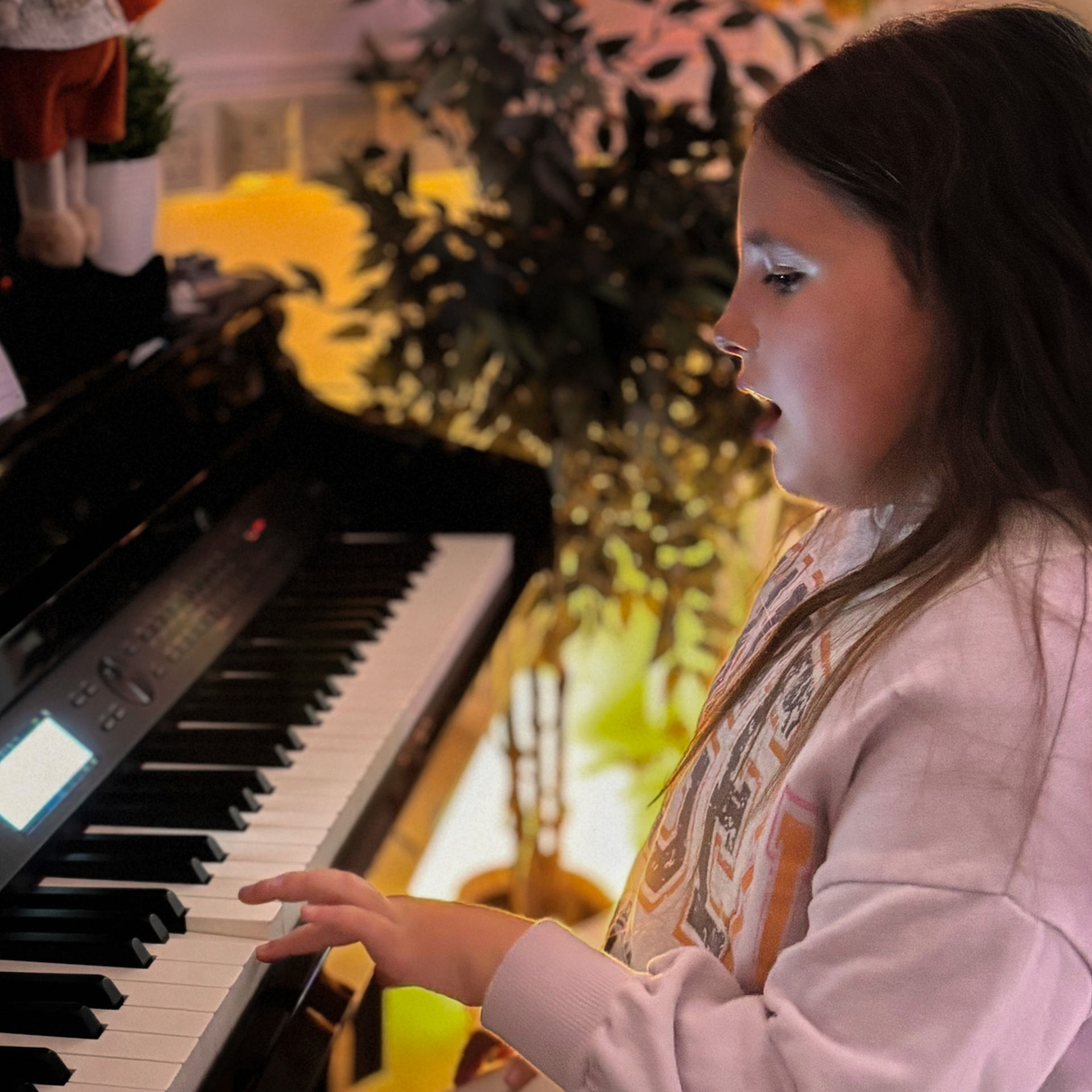 Connie singing at the piano in Encore's Vocal Studio.