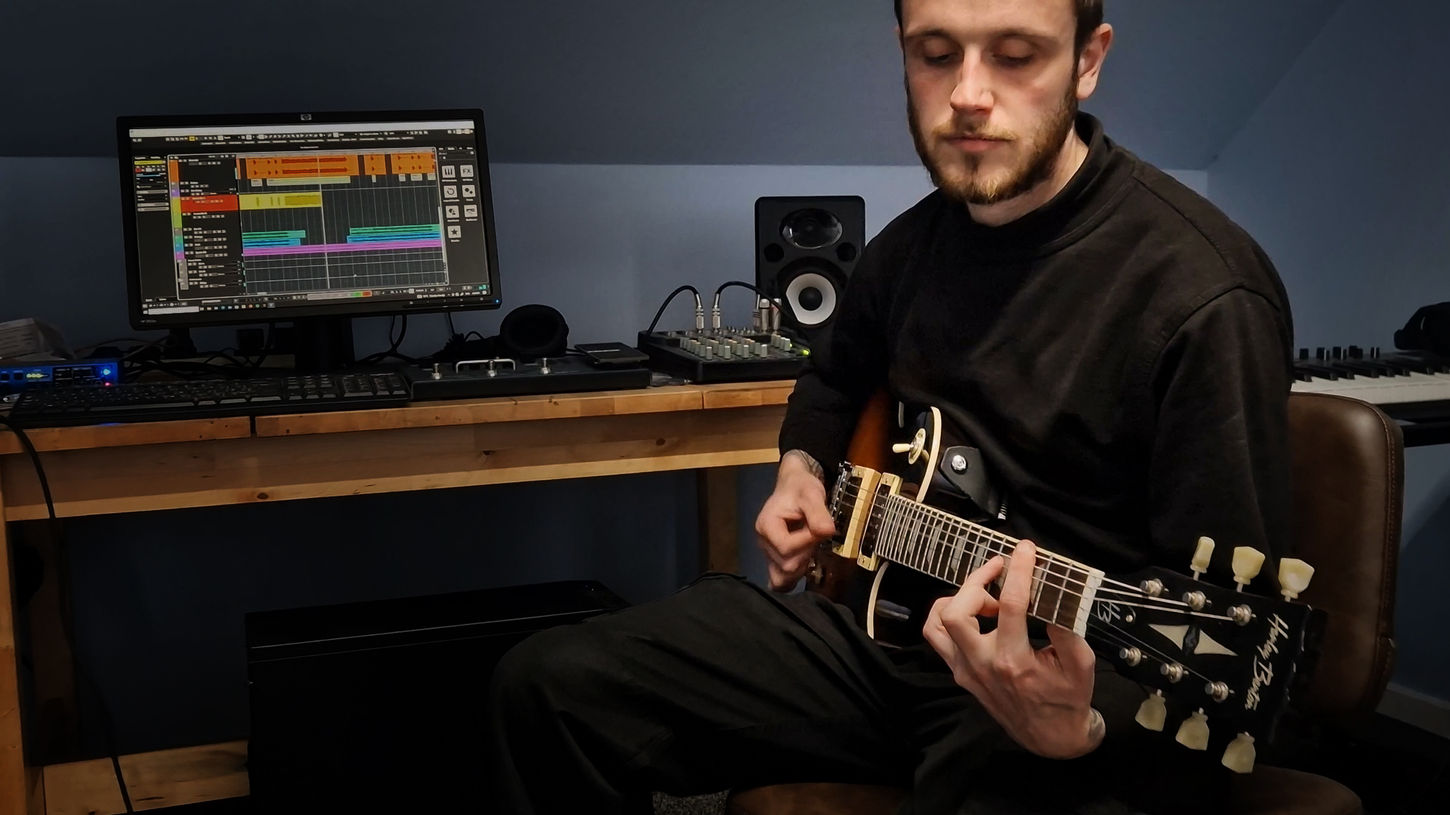 Jamie enjoys recording guitar riffs in a fun guitar lesson.