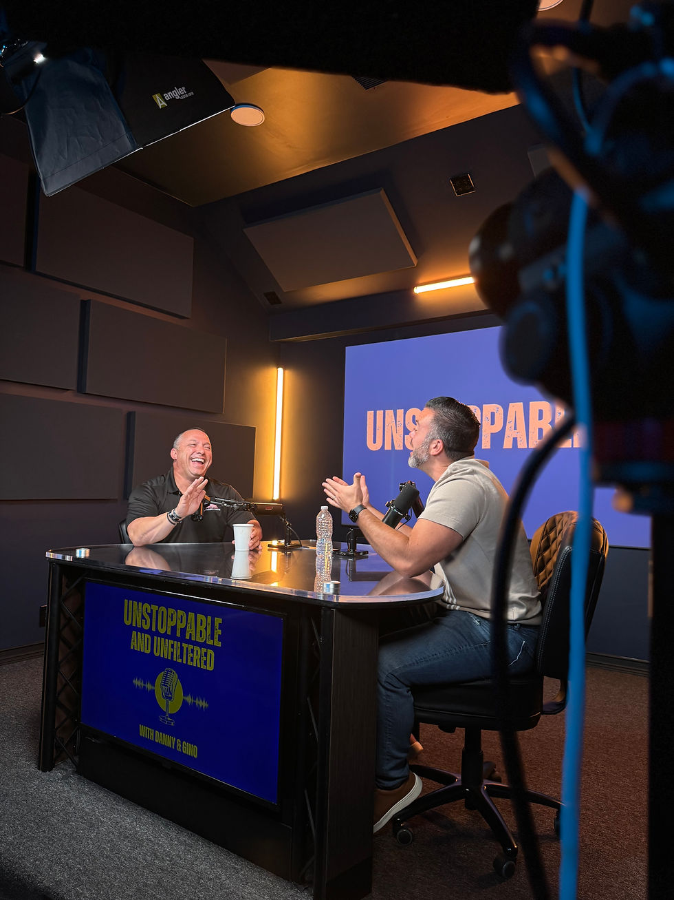 Danny and Gino recording Unstoppable Me Podcast on leadership, resilience, trust, and high-performance coaching.