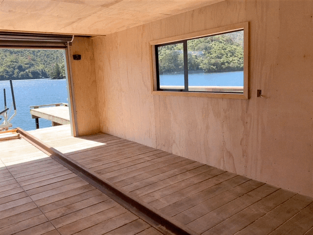 looking out over the water from boatshed in marlborough sounds we have completed building