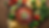 A top down view of a wooden bowl full of vibrant salsa surrounded by chips, tomatoes, whit