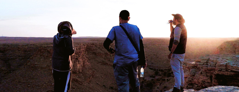 The Sunset Valley is where hikers enjoy watching the sunset. These hikers enjoy the enigmatic sunset light..