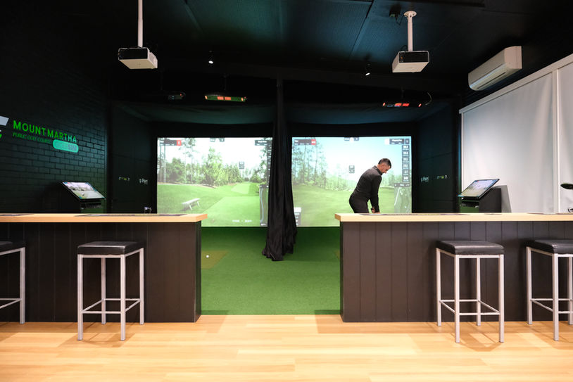 Dual-bay golf simulator setup at Mt Martha Golf Club with Uneekor tracking, GSPro software, and premium bar-style seating — installed by Golfsim Australia.