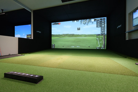 Golfsim Australia demo facility featuring a premium indoor golf simulator with widescreen projection and custom turf flooring.