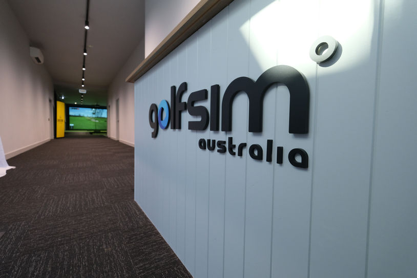Golfsim Australia showroom entrance featuring brand signage and corridor view into indoor golf simulator space.