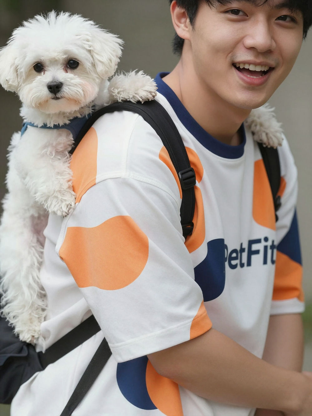 Man with white dog in carrier, wearing a PetFit tee