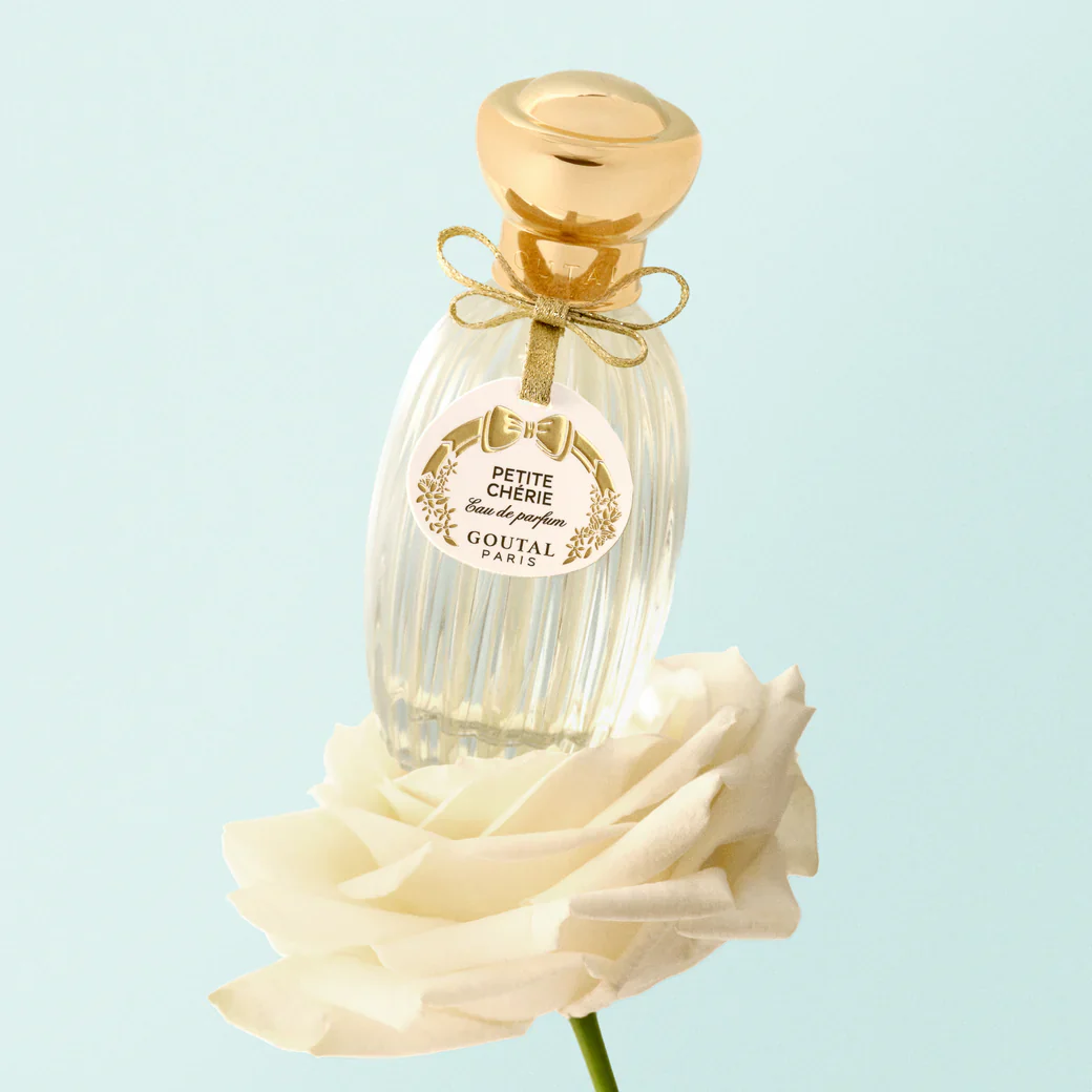 clear perfume bottle with gold cap and ribbon