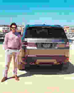 Yusof Mutahar Posing with His Range Rover