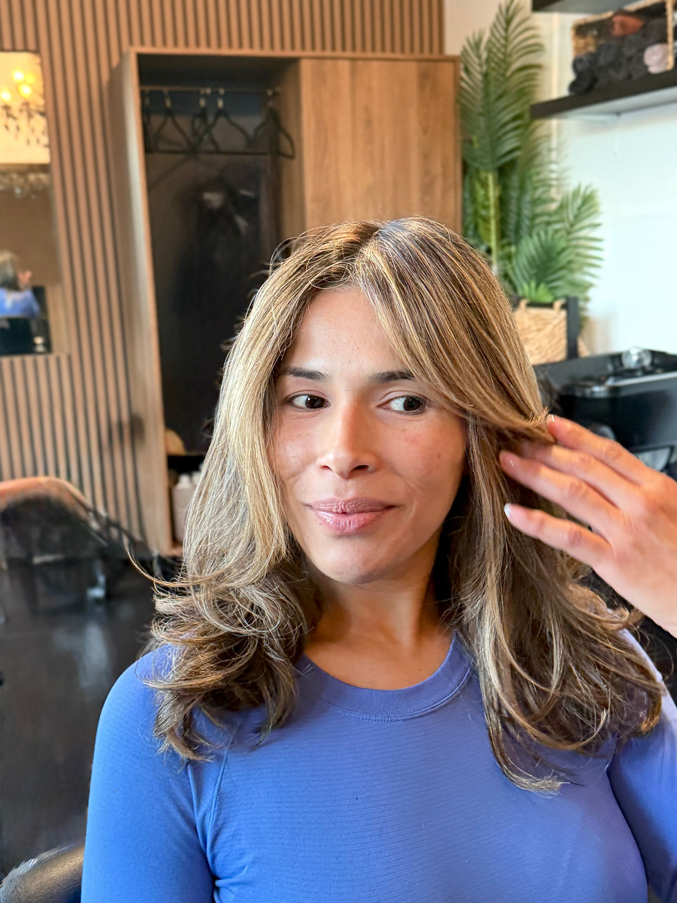 Dimensional blonde highlights with soft waves.
