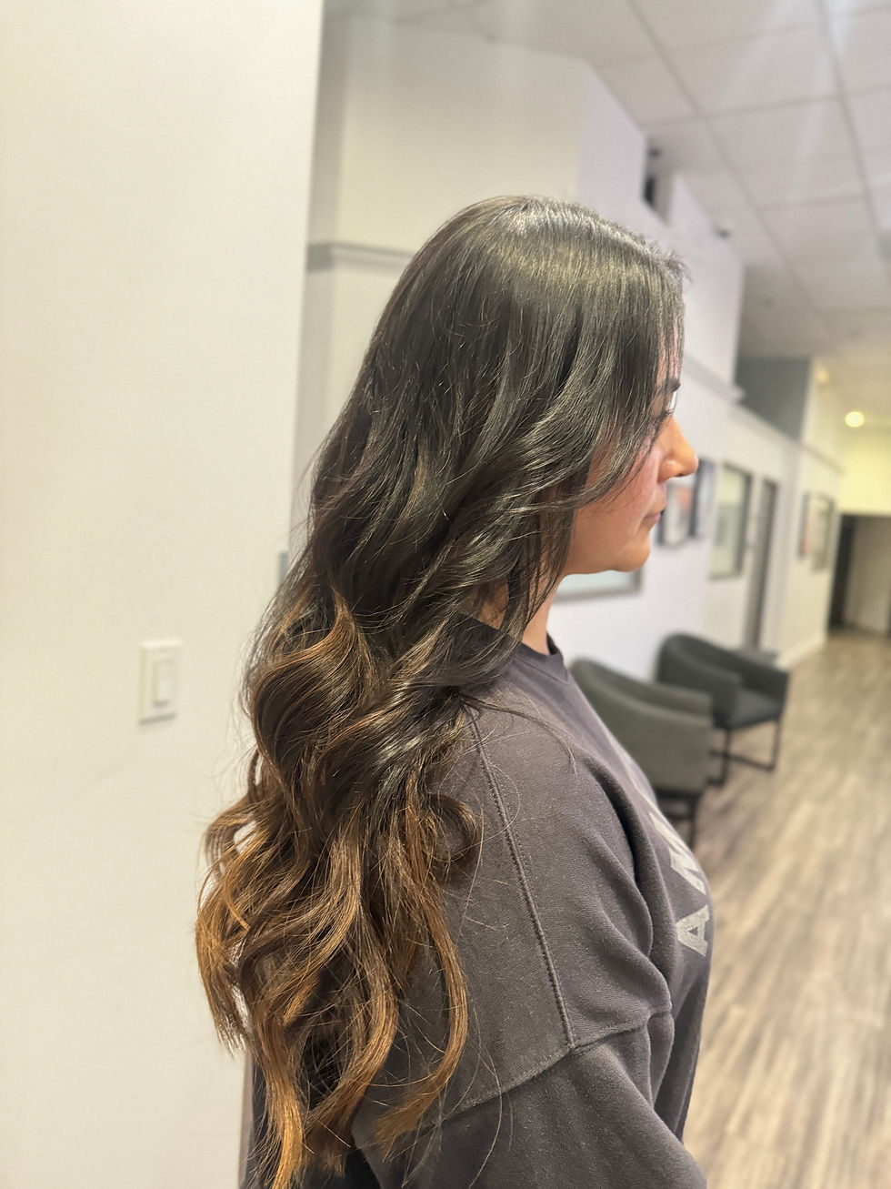 Long layered hairstyle and k-tips with soft curls.