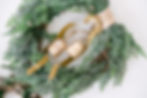 Christmas wreath with golden bells laying on a table