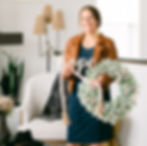 Women Holding a flocked wreath and the word hope in a living room