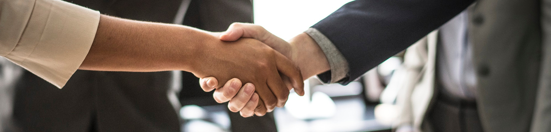 business-people-shaking-hands-meeting-room.jpg