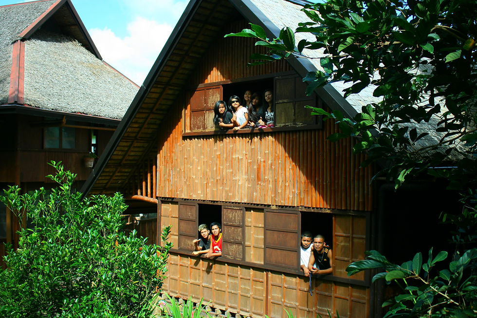 Lilok Farm visitors peeking through the windows of a nipa hut.
