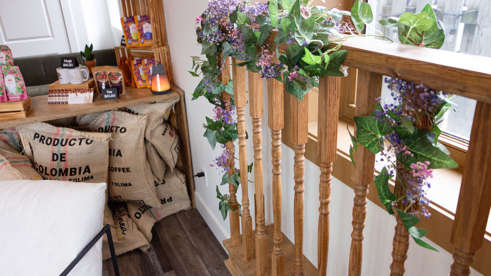 Cozy interior with wooden railing and floral decorations.