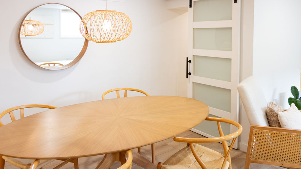 Modern dining room with wooden table and chairs.