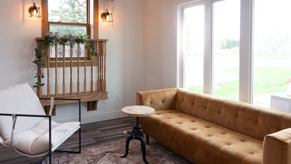 Cozy room with a couch and large window.