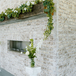 ceremony site with brick fireplace at rustic barn wedding venue