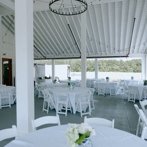 White flower centerpiece at rustic barn wedding venue