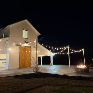 Fire pit at white barn wedding and event venue at night