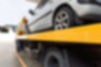vehicle on flat bed truck