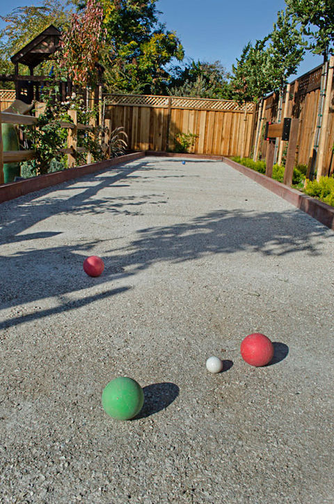 Backyard with bocce ball court and children's playground