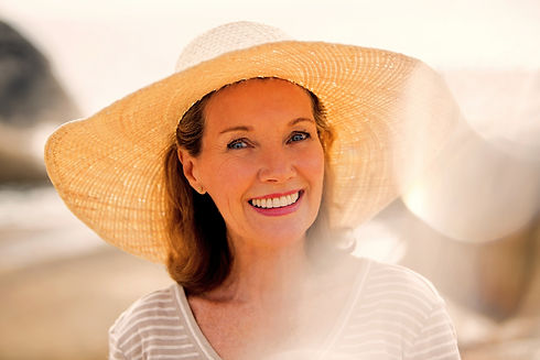Older woman wearing straw hat on beach_edited.jpg
