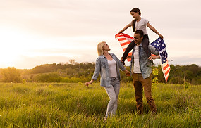 beautiful-family-with-the-american-flag-in-a-field-2025-01-10-02-22-39-utc.jpg