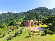 Aerial view of Shandelle Lauren surrounded by orchards and Northern Range hills