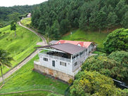 Elevated aerial view of Cloud 9 surrounded by lush tropical vegetation