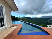 Infinity pool and hot tub at The White House with Northern Range views