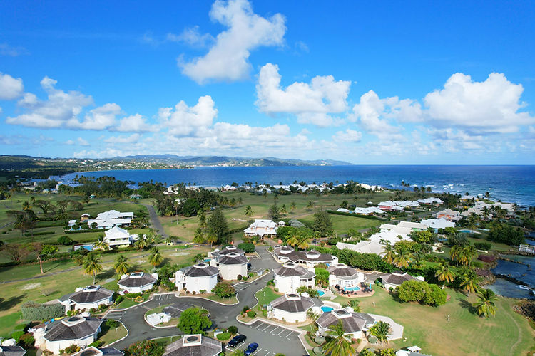 Aerial view of Tobago Plantations Estate in Lowlands, Tobago, with villas, golf course and Atlantic coastline.