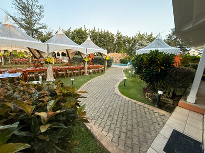 White event tents and long reception tables arranged across the lawn at The Lauren Taylor Villa