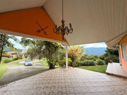 Covered outdoor terrace at Drogeda overlooking the landscaped estate grounds