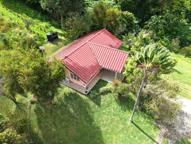 Overhead view of Drogeda residence nestled among lush Northern Range vegetation