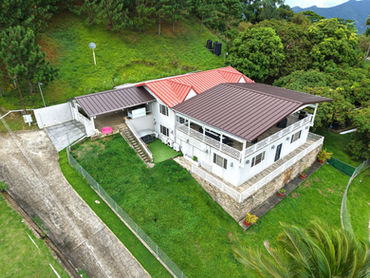 Aerial perspective of Cloud 9 residence, driveway and landscaped lawn