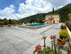 Paved courtyard and approach to Shandelle Lauren beneath the Northern Range