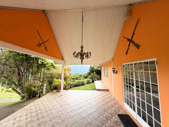 Spacious covered veranda at Drogeda with views across the surrounding gardens