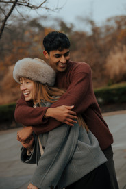 Couple having fun at Conservatory Garden Central Park engagement photos
