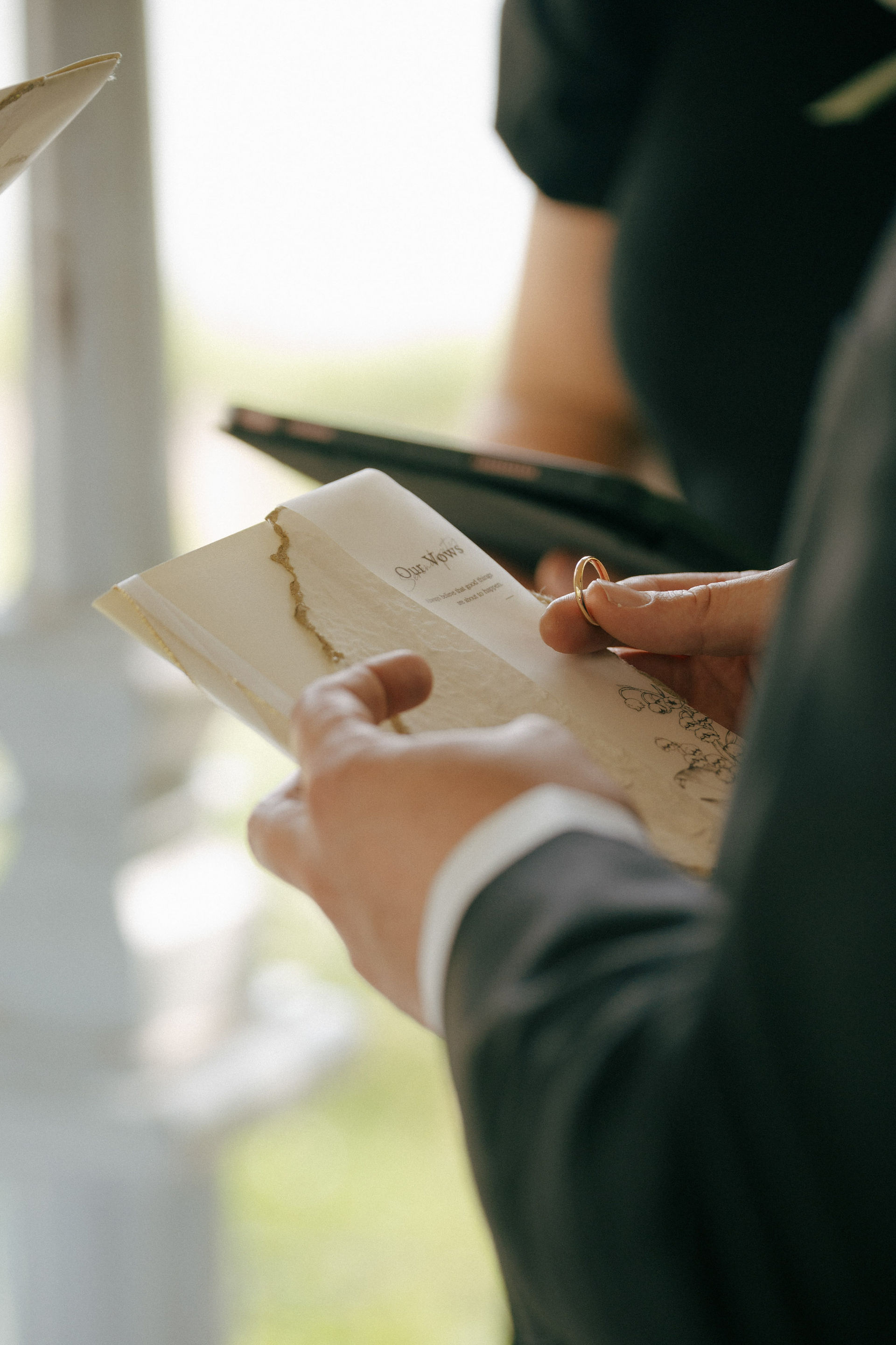 Central Park elopement, groom reading vows from book, springtime New York elopement photography
