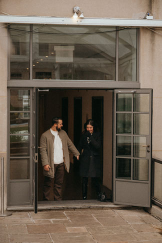 Couple entering 620 Loft and Garden Surprise proposal during NYC photoshoot, romantic moment, winter coats