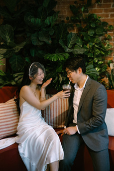 Bride and groom relaxing in cozy Brooklyn café after courthouse wedding, intimate Brooklyn elopement photographer