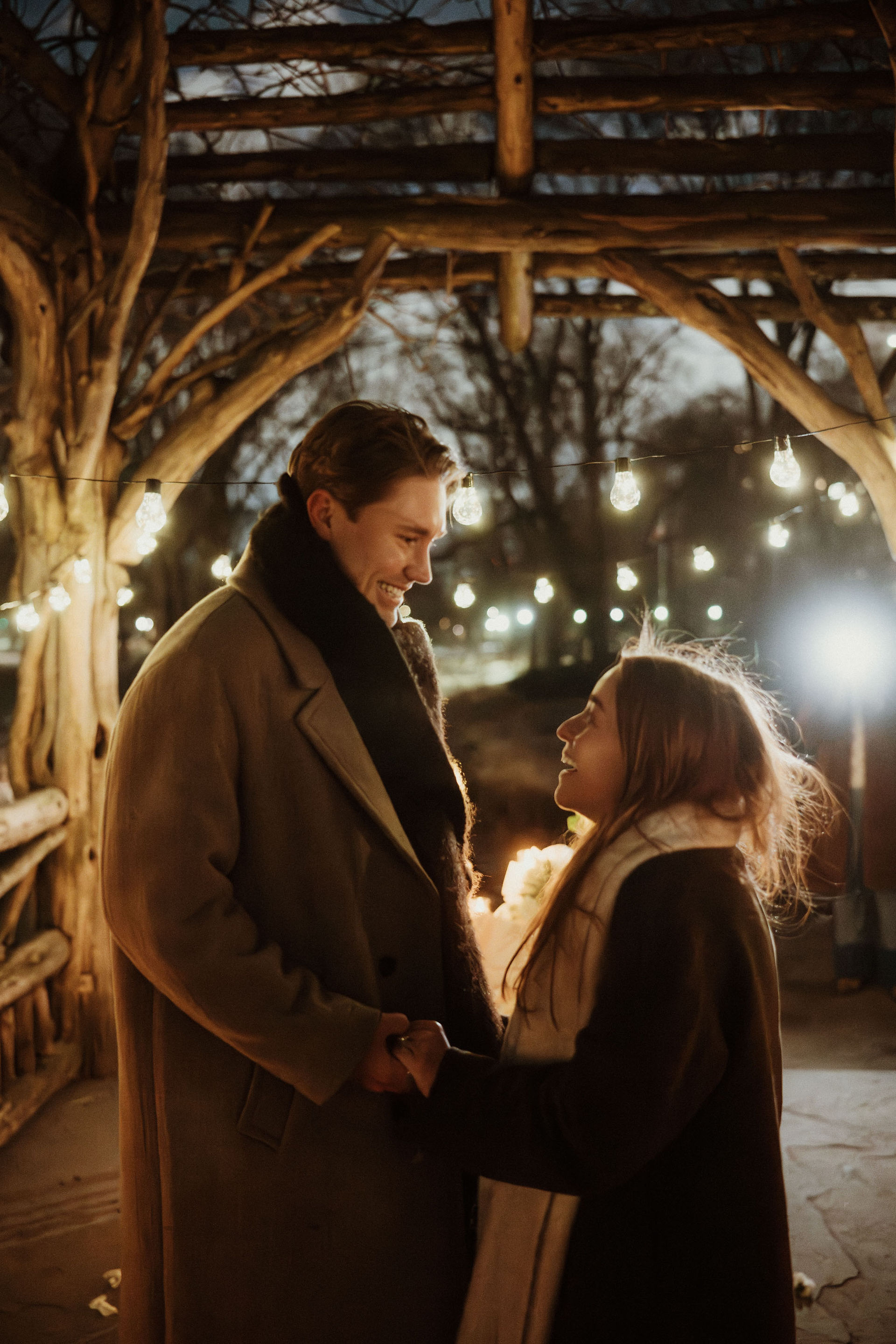 Holiday proposal NYC under string lights in Central Park photographed by documentary NYC proposal photographer