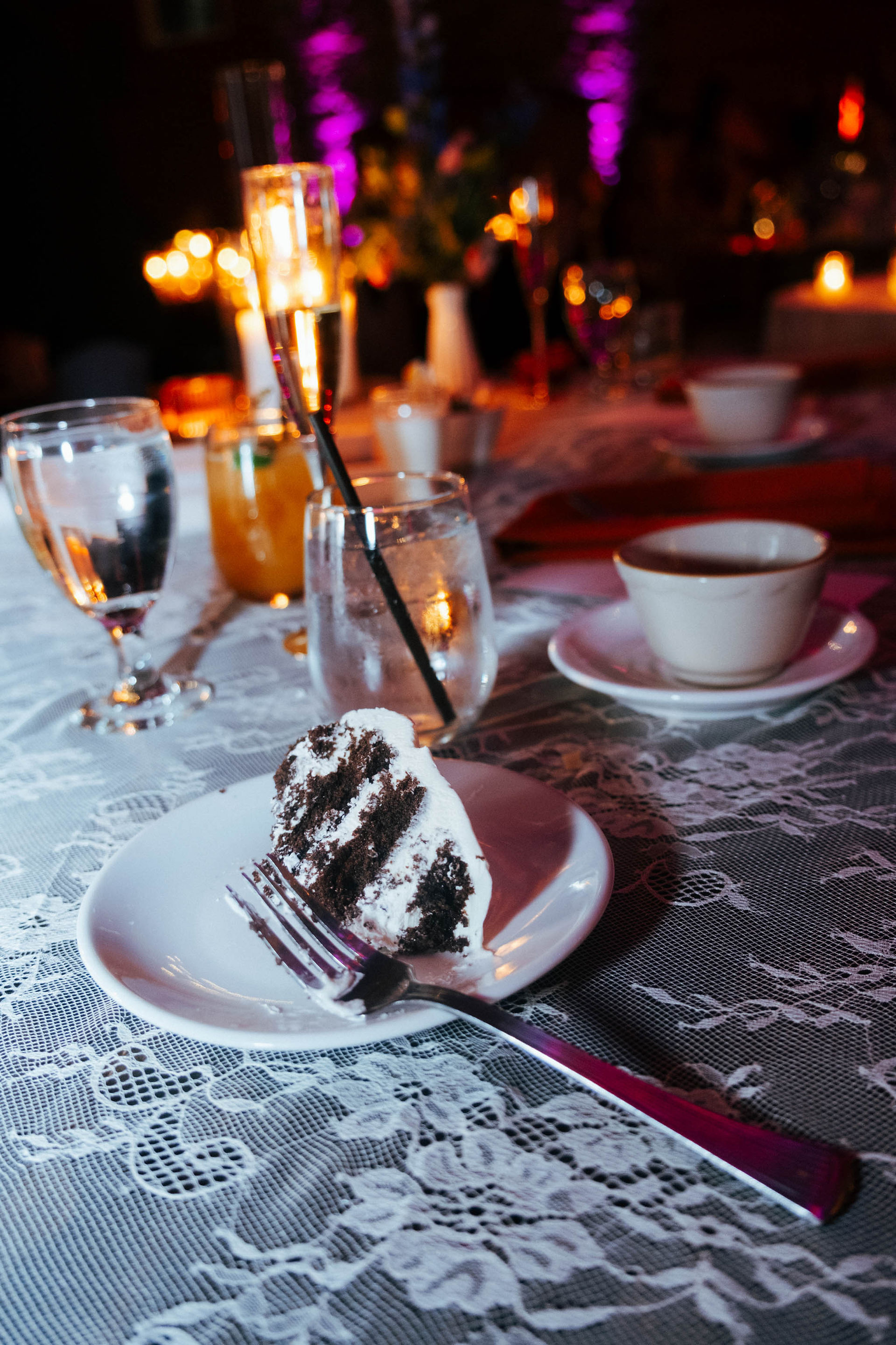 lifestyle candid wedding detail shot chocolate cake candles moody romantic reception table
