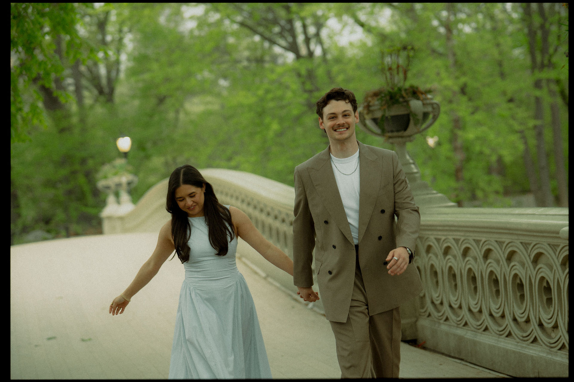 Romantic spots in Central Park, couple at Bow Bridge spring engagement session cinematic photoshoot