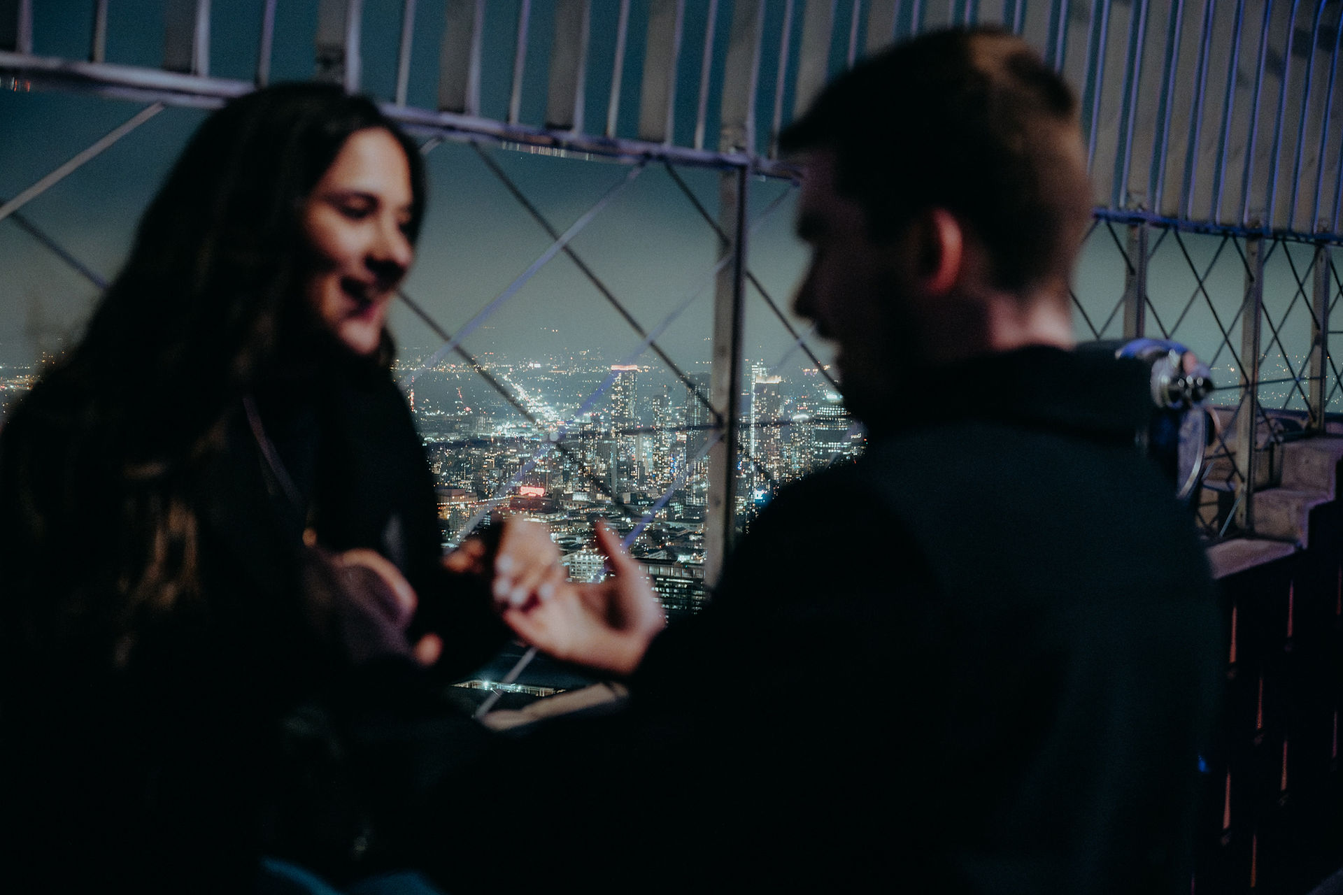 Romantic surprise proposal photoshoot couple standing at Empire State Building NYC at night