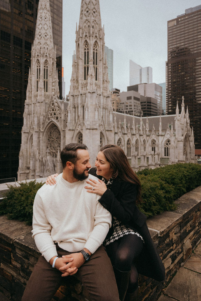 Couple photoshoot at St. Patricks Cathedral NYC with skyscrapers backdrop, marriage proposal, wedding at 620 Loft and Garden