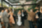 Bride and guests cheering during wedding reception at Aurora garden venue