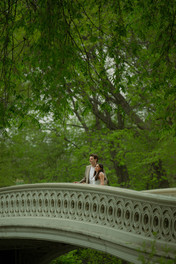 Romantic spots in Central Park, couple at Bow Bridge spring engagement session cinematic photoshoot