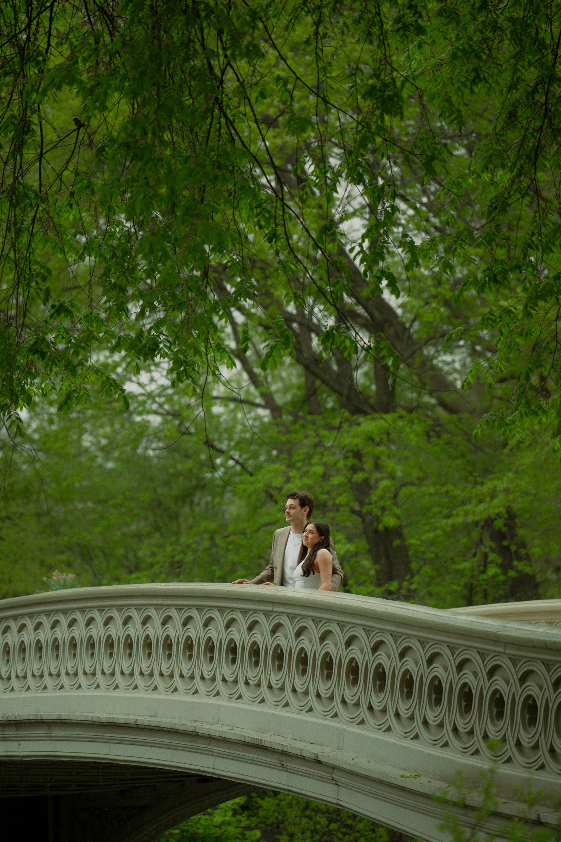 Romantic spots in Central Park, couple at Bow Bridge spring engagement session cinematic photoshoot